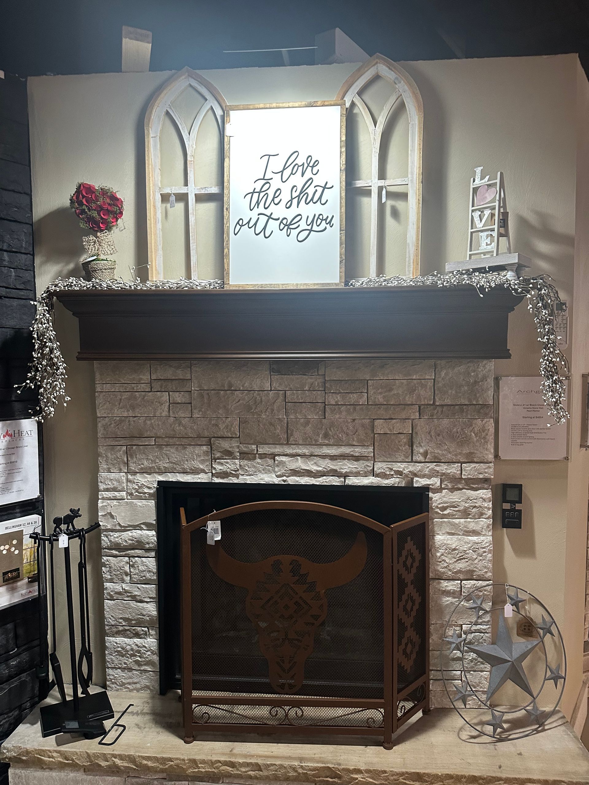 A fireplace with a sign above it that says i love you