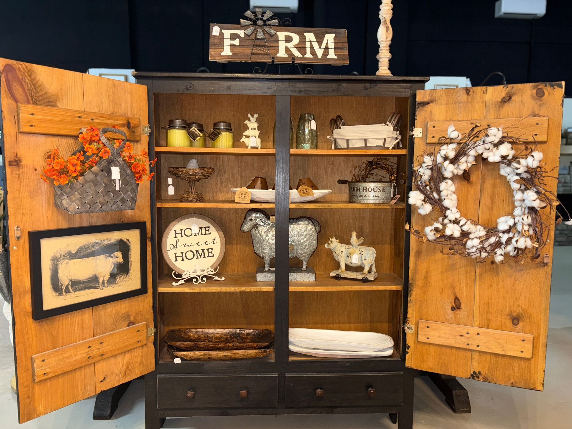 a wooden cabinet with the doors open and a sign that says farm on it