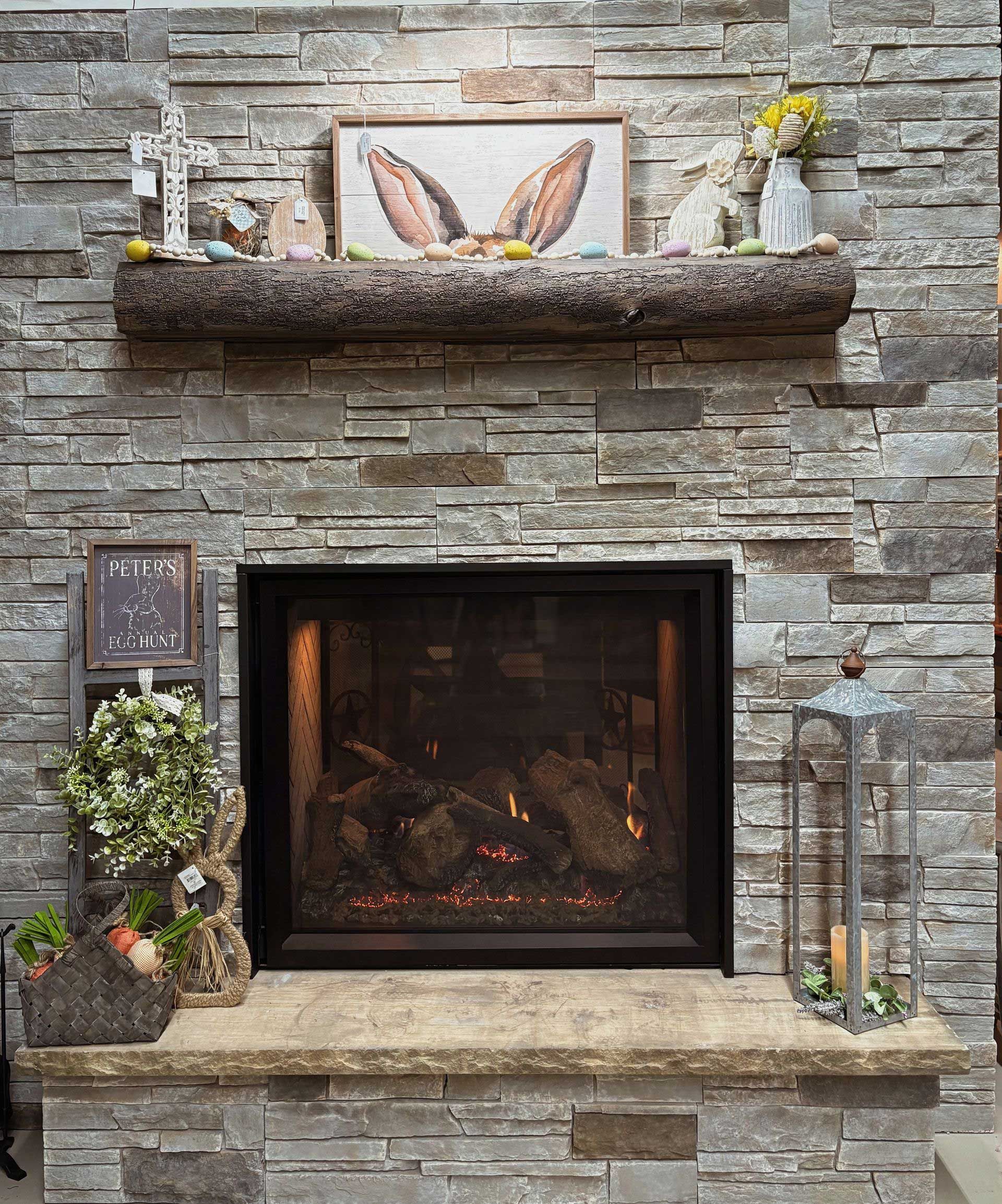 a fireplace with a picture of rabbit ears on the mantle