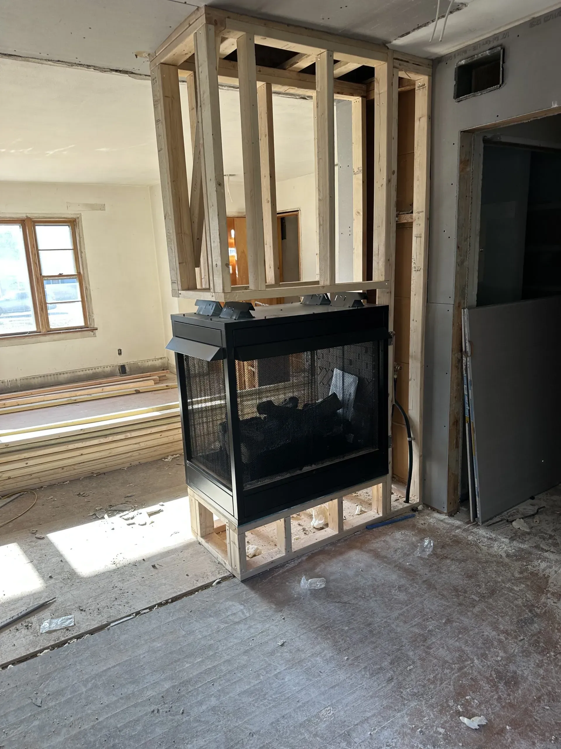 A fireplace is being built into the wall of a house.