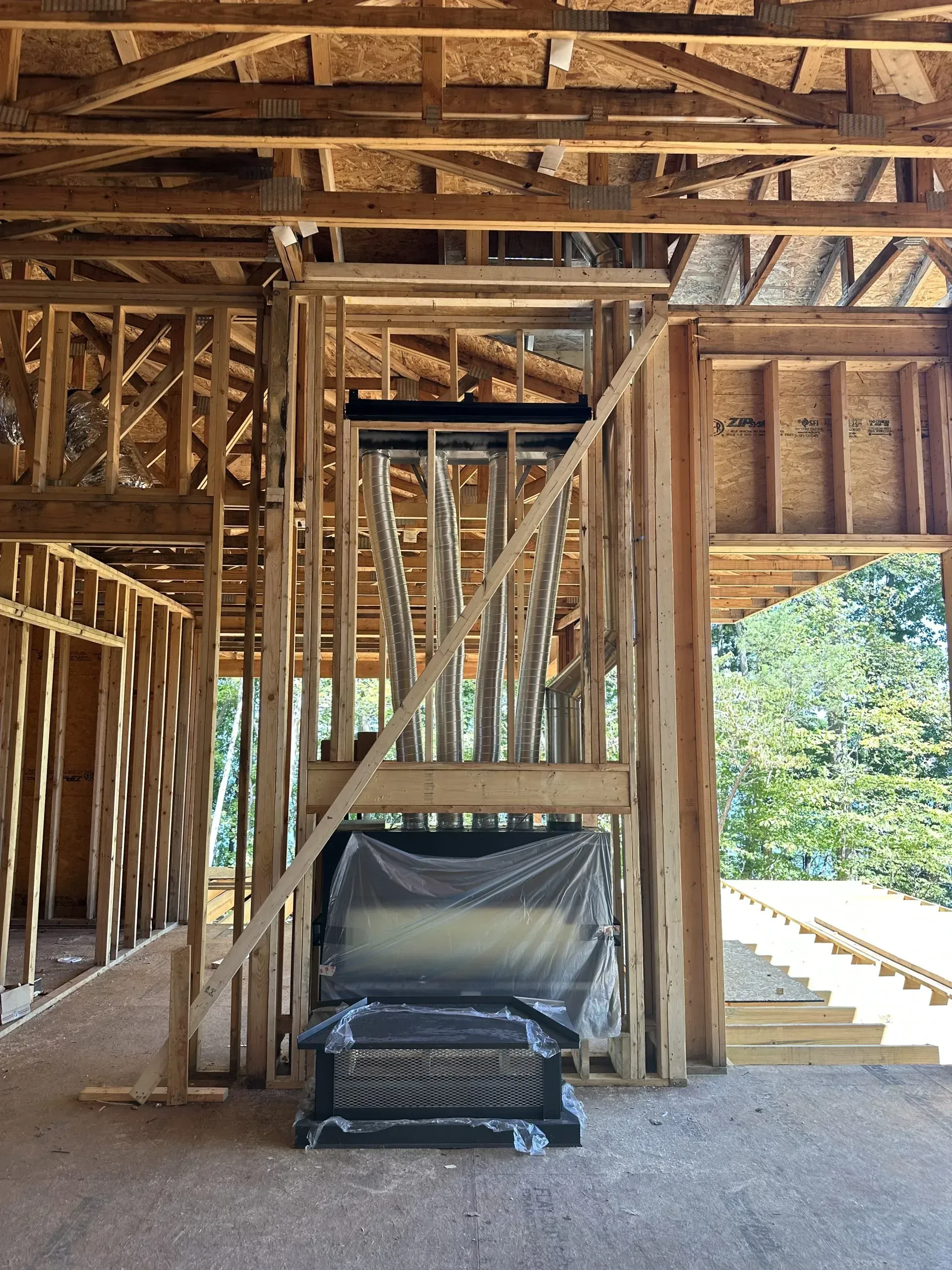 A house is being built with a fireplace in the middle of the room.