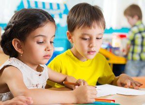 a girl and a boy answering a book exercises