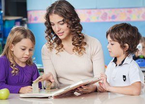 teacher teaching private lessons on two kids