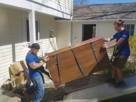 Movers loading furniture into truck