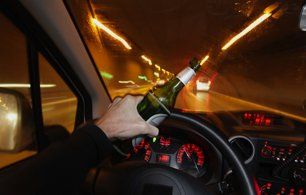 Driving with bottle beer on hand