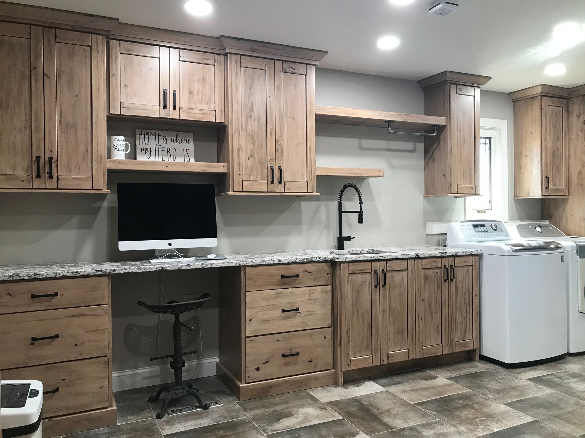 Room with wooden cabinets and washer on the side