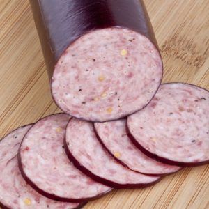 A close up of sliced sausage on a cutting board