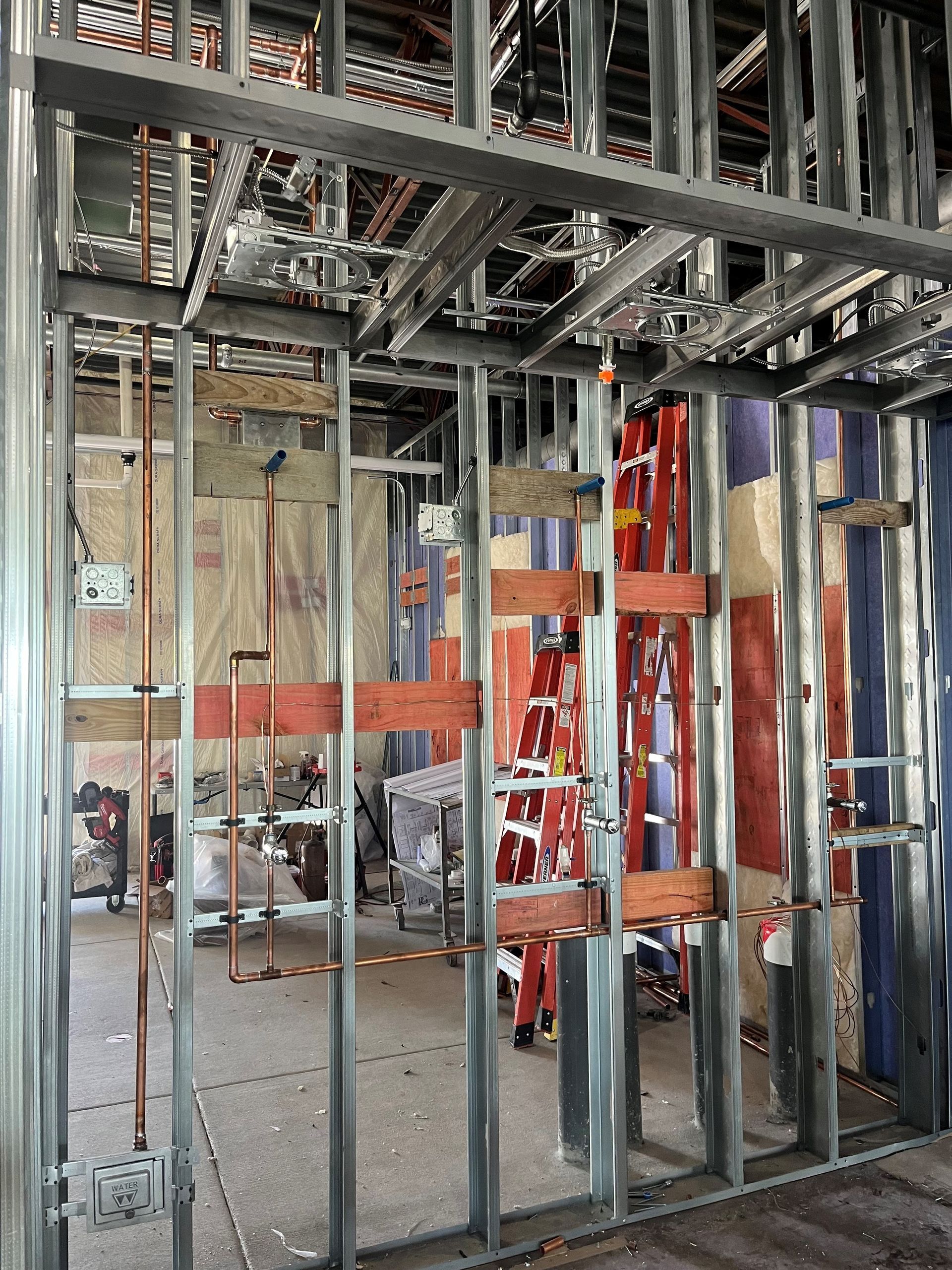 A room under construction with a ladder in the middle