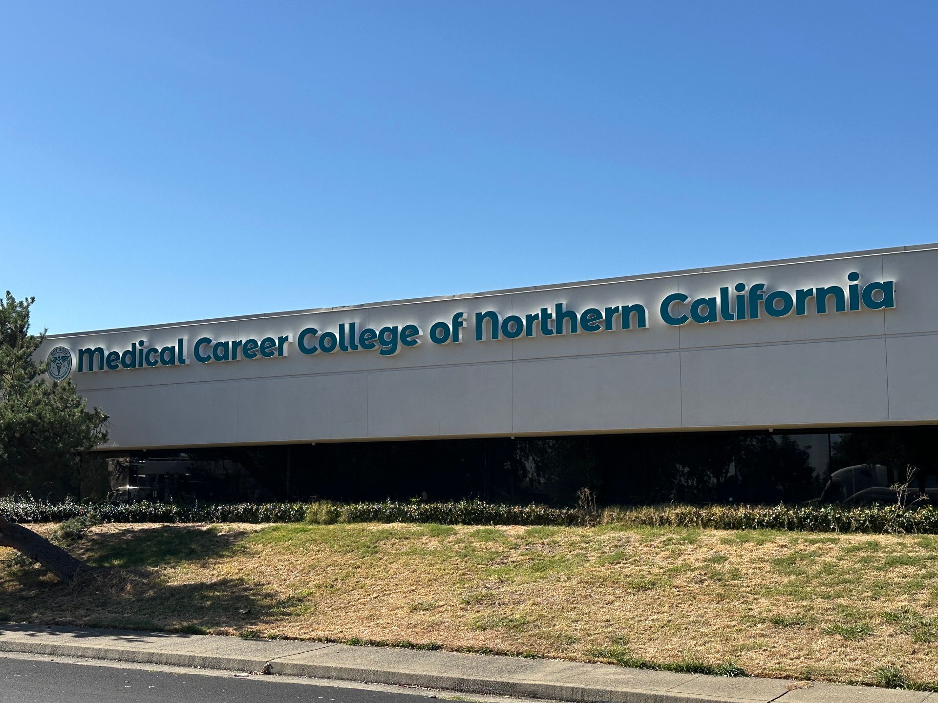 Medical Career College of Northern California building with blue signage under a bright sky.