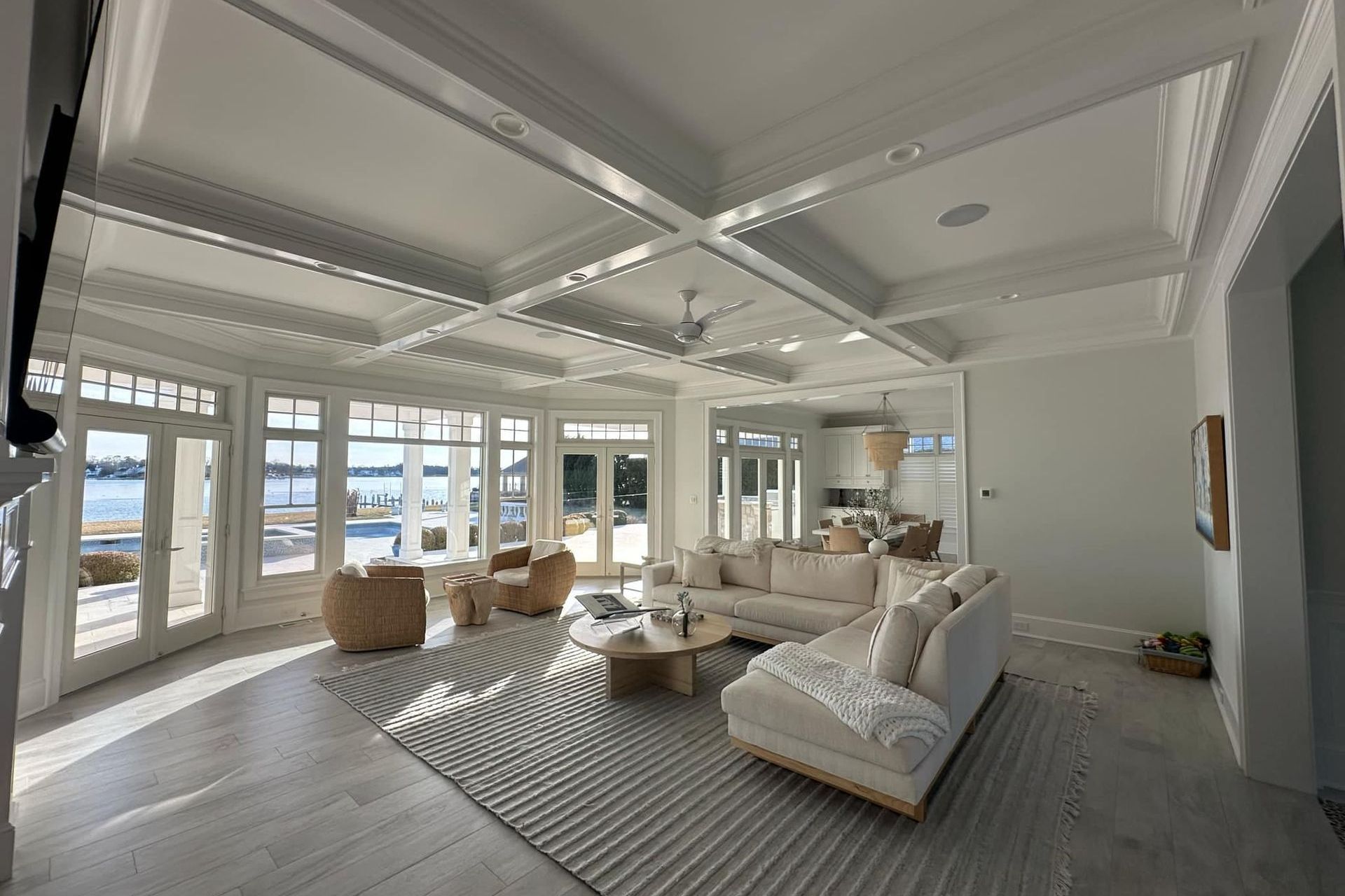 A living room with a couch, chairs, and a rug.
