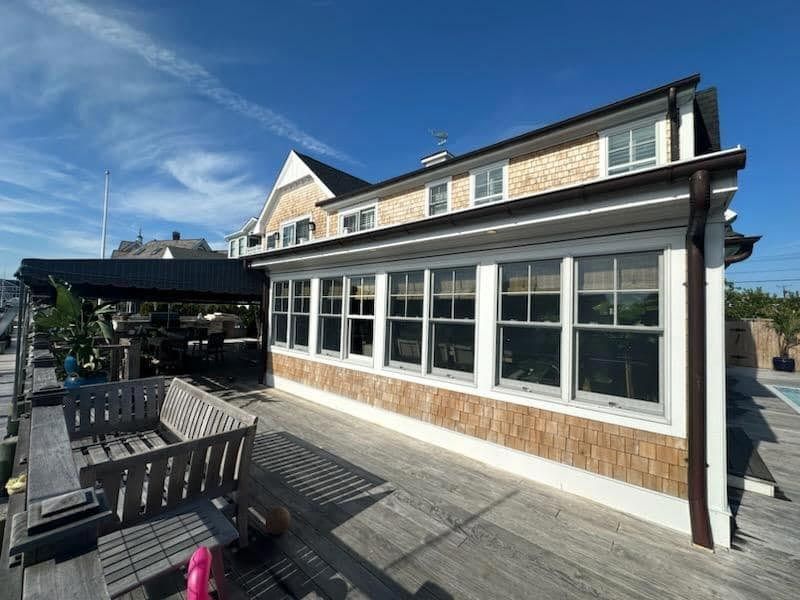 A large house with a lot of windows and a wooden deck