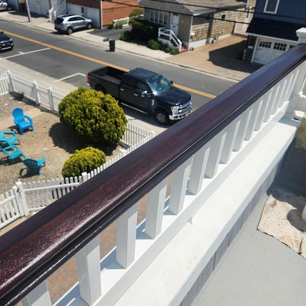 A black truck is parked on the side of the road