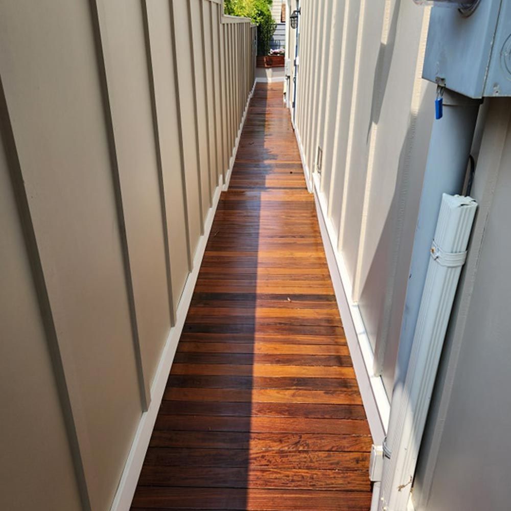 A long wooden walkway between two buildings