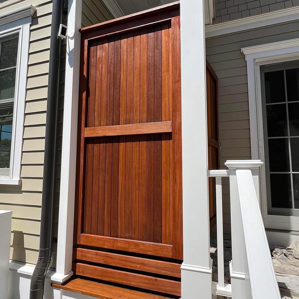 A wooden door on the side of a house