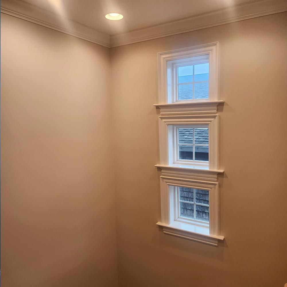 A room with three windows on the wall.