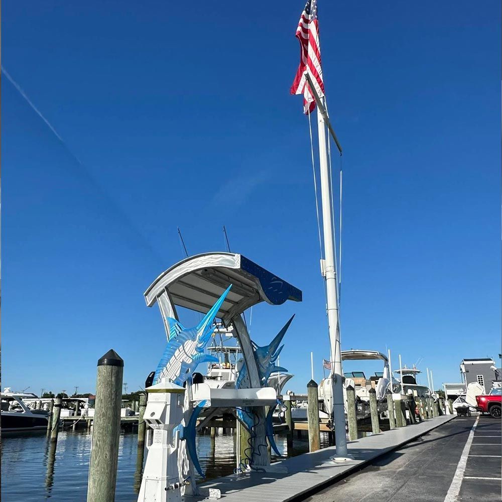 A dock with a statue of a fish and an american flag