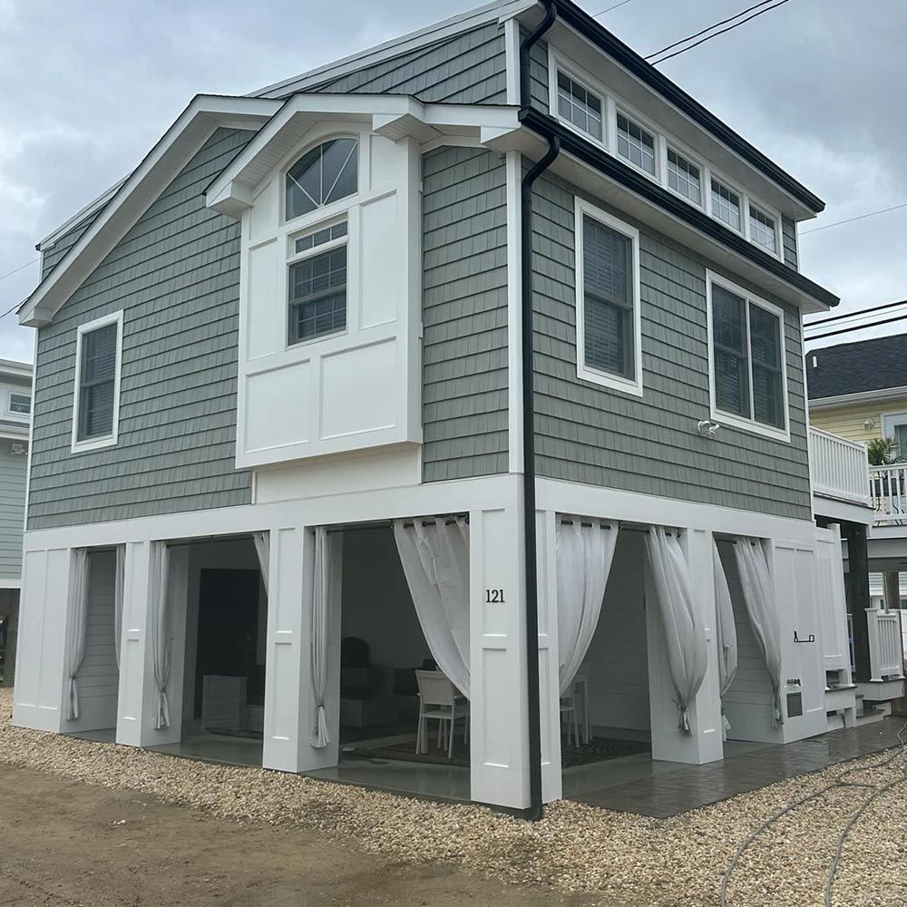 A large house with a lot of windows and curtains