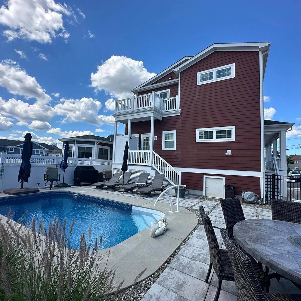 A large house with a swimming pool in front of it
