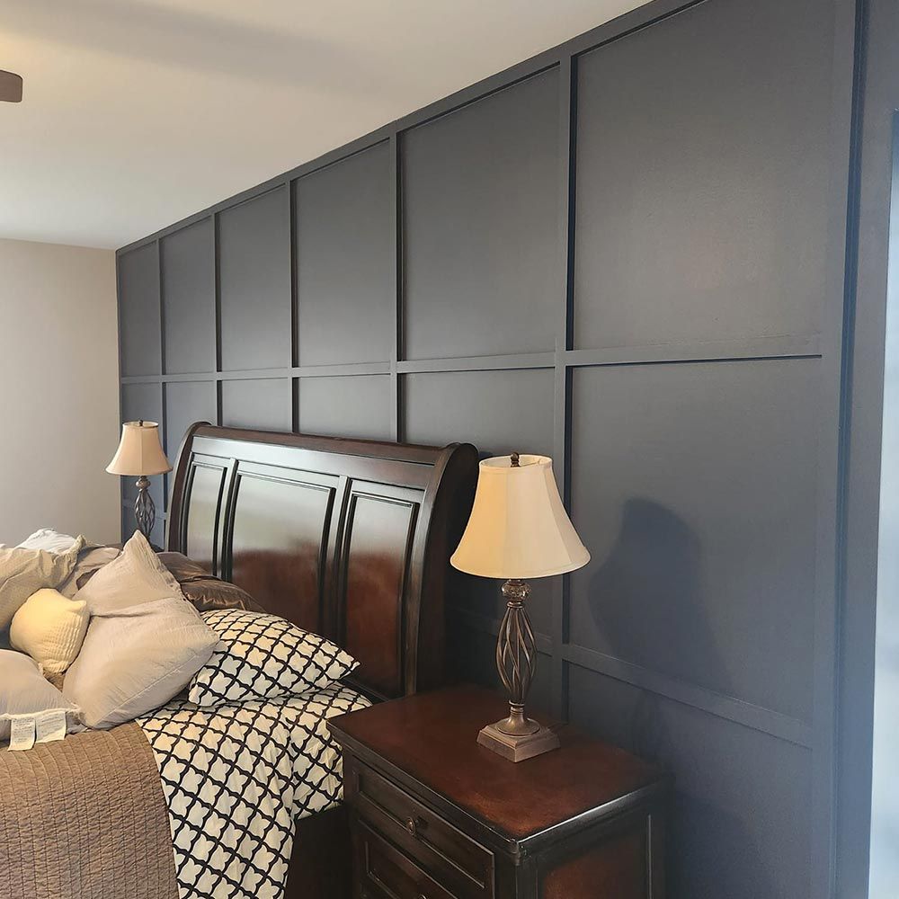 A bedroom with a bed , nightstand , and two lamps.