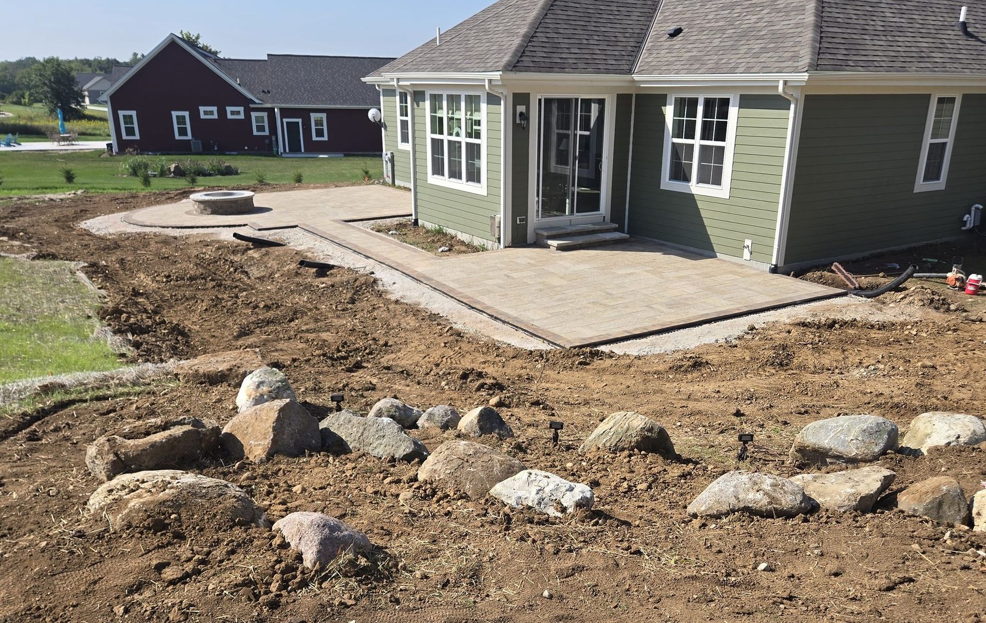 A green house with a patio in front of it
