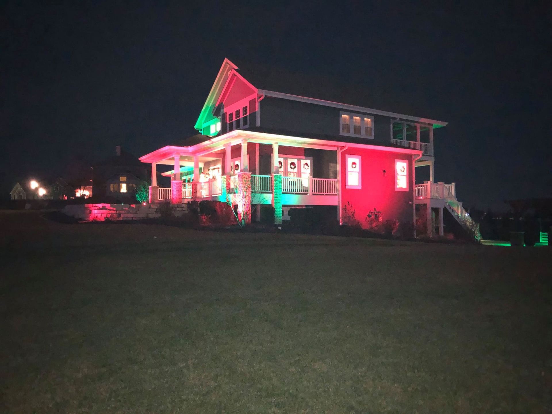 A house is lit up with red and green lights at night