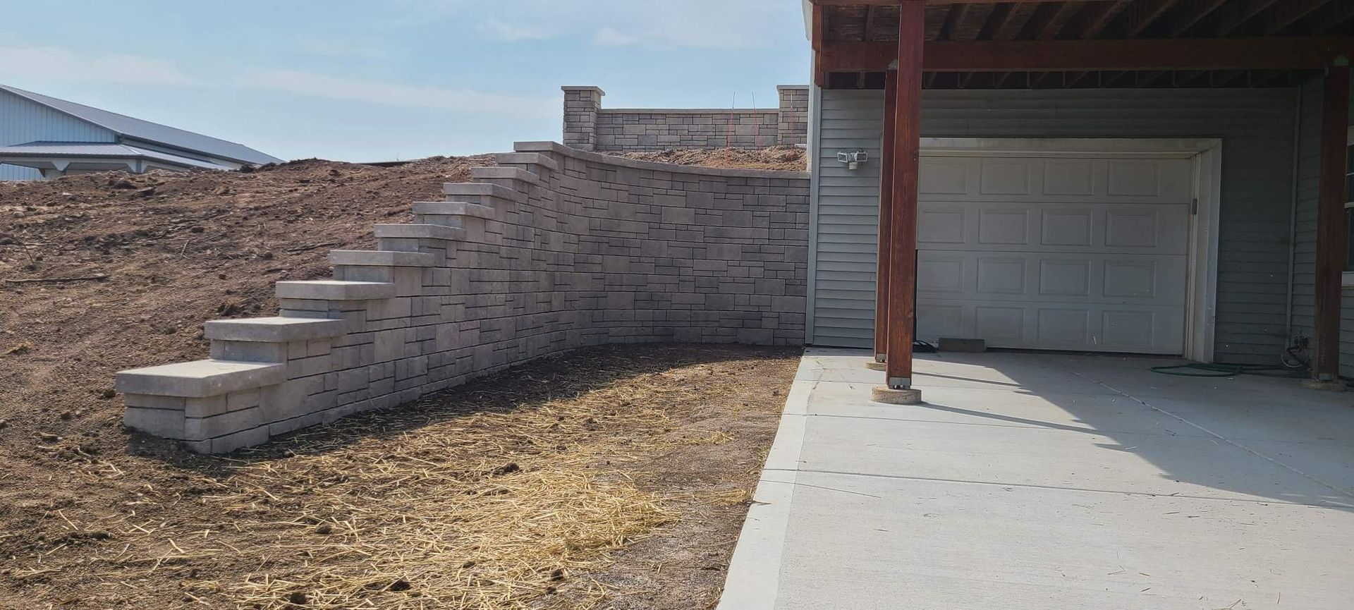 A house with a garage and stairs leading up to it.
