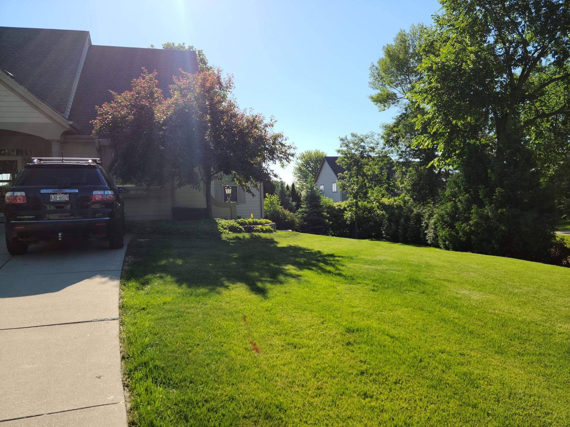 A black suv is parked in front of a house