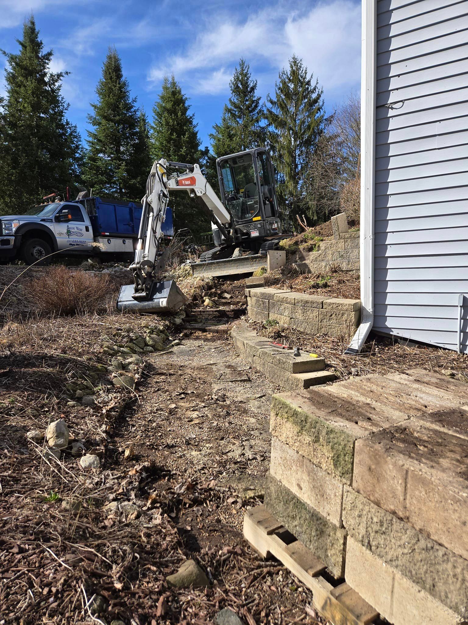 A white truck is parked in front of a house.