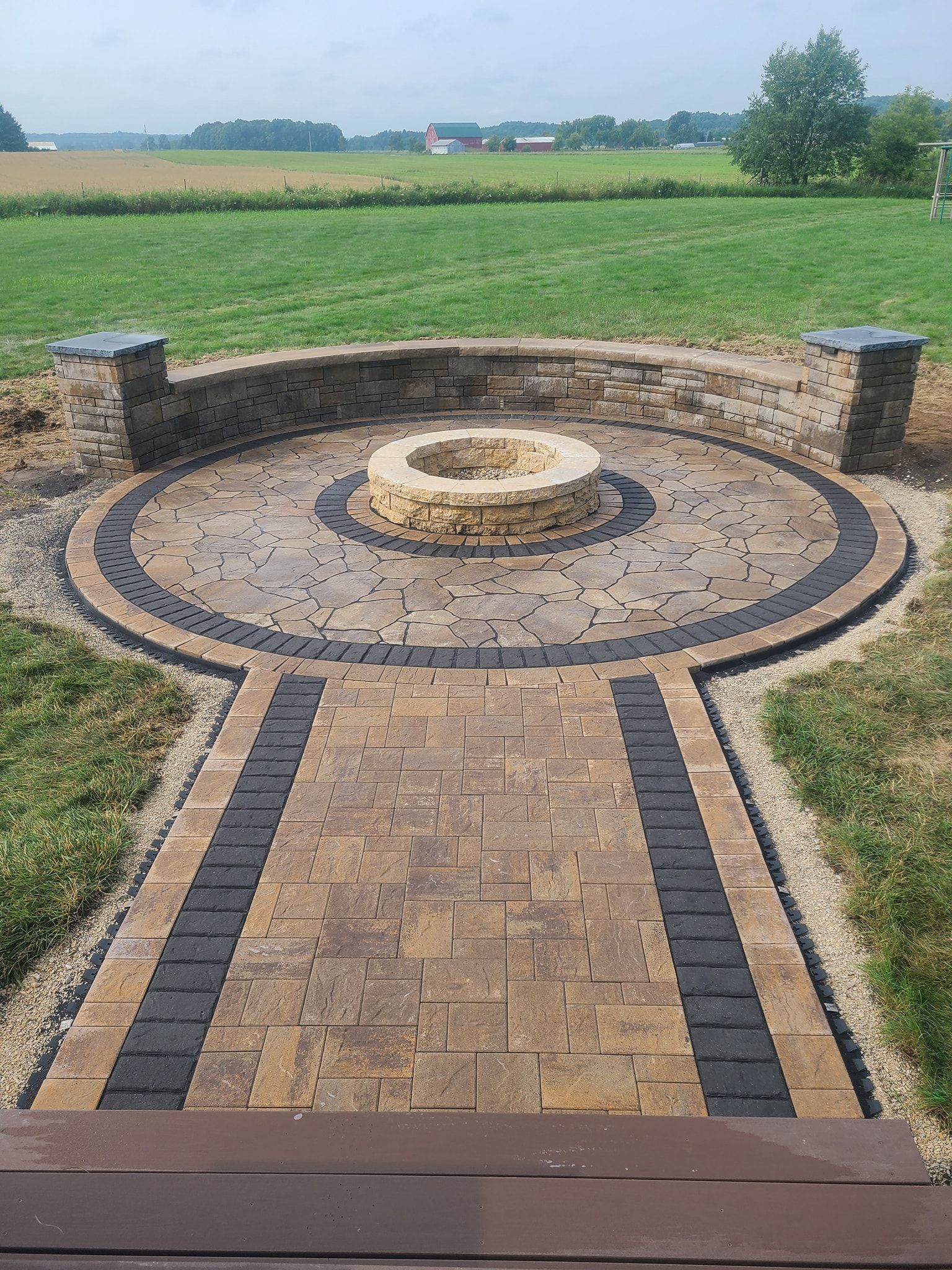 There is a fire pit in the middle of the patio.