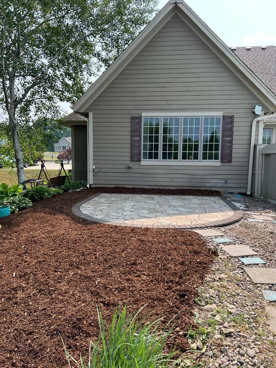 A small house with a patio in front of it.