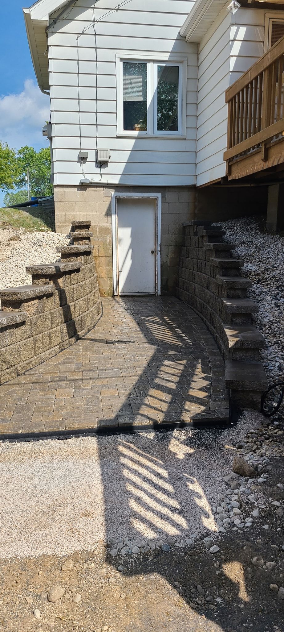 A white house with stairs leading up to it and a white door.