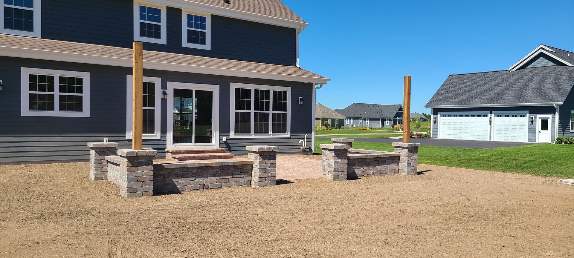 A large house with a patio in front of it.