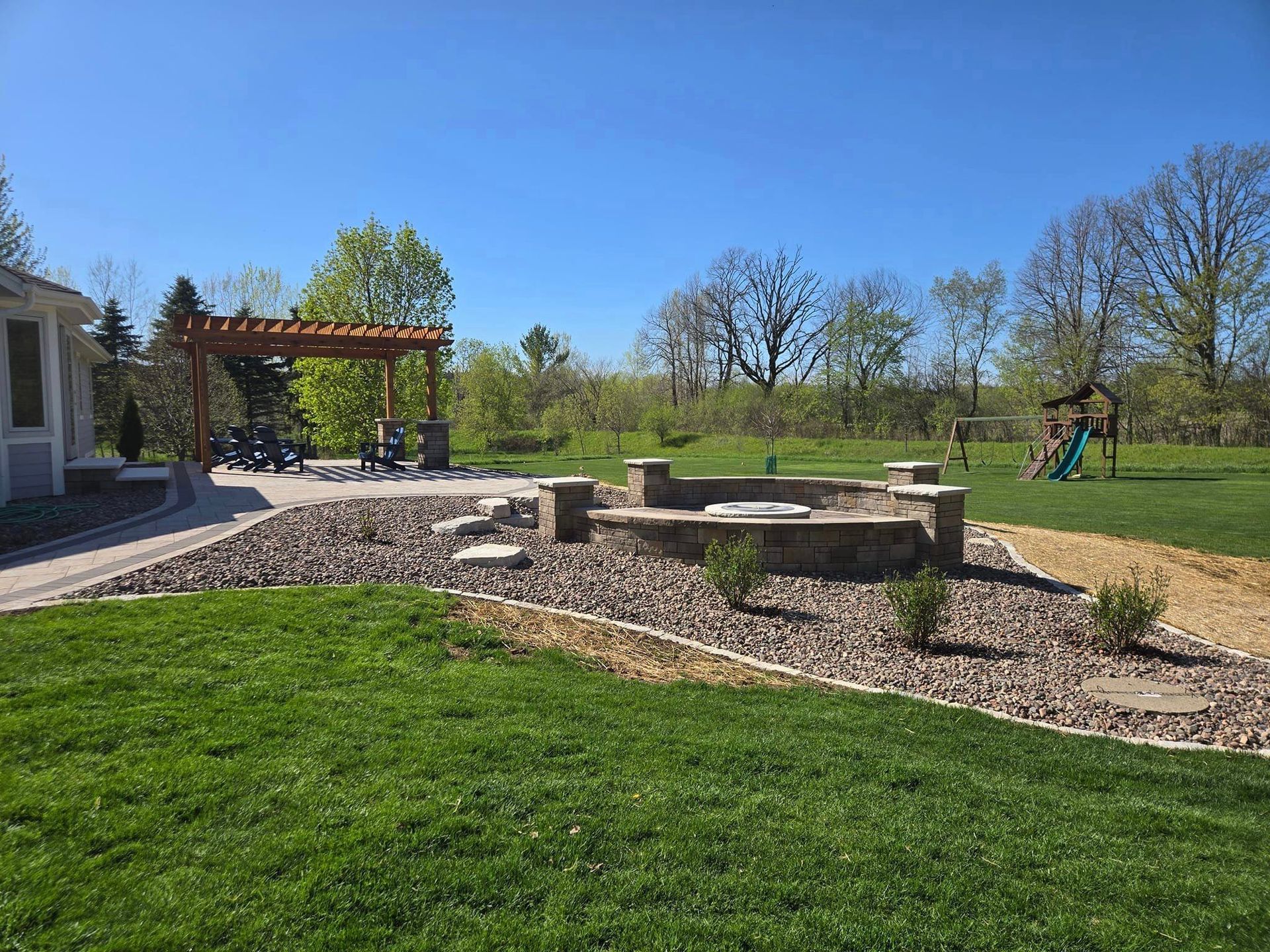 There is a fire pit in the middle of the backyard.