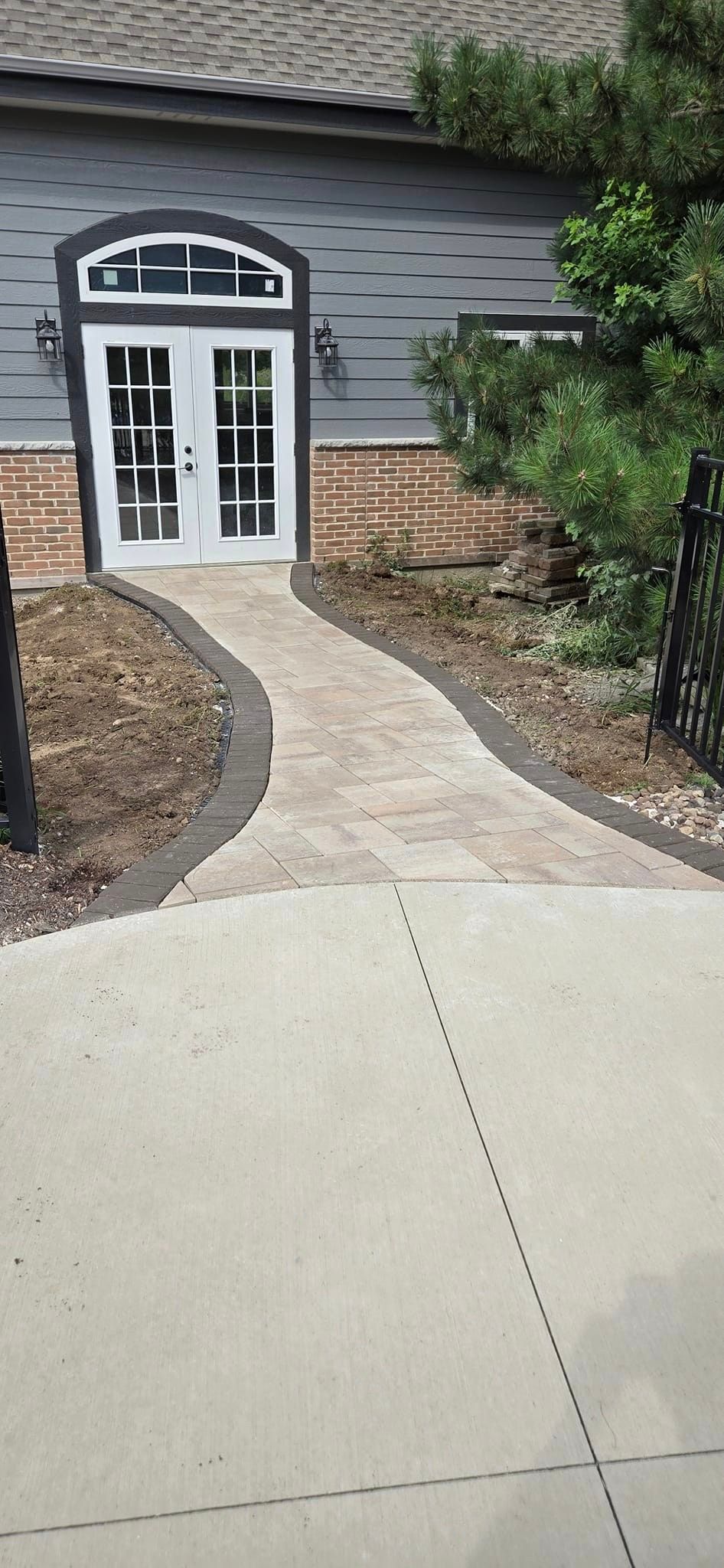 There is a walkway leading to the front door of a house.