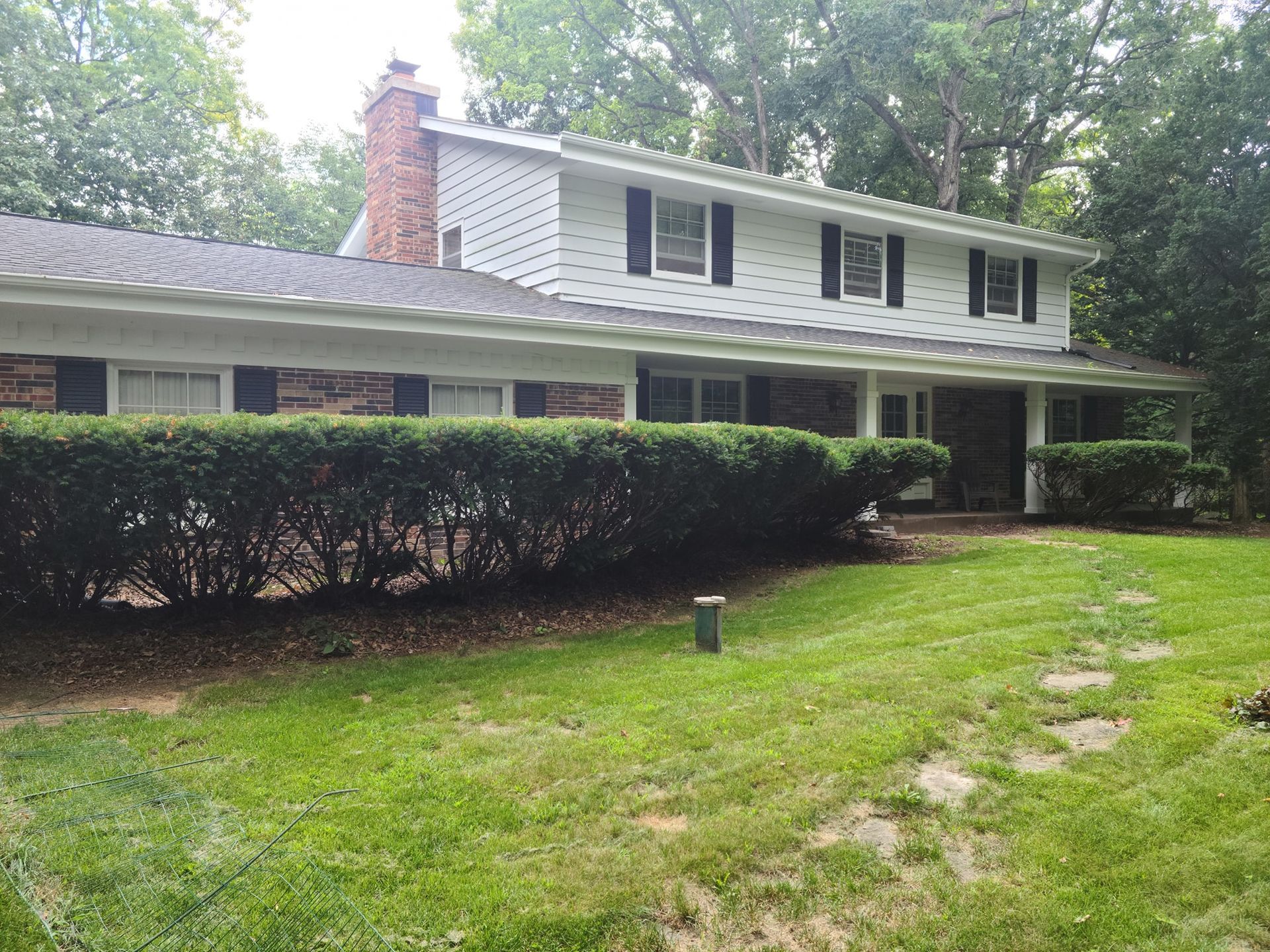 A large white house with a large lawn in front of it