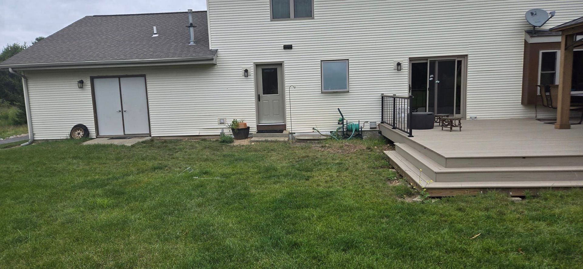 A large white house with a large lawn in front of it.