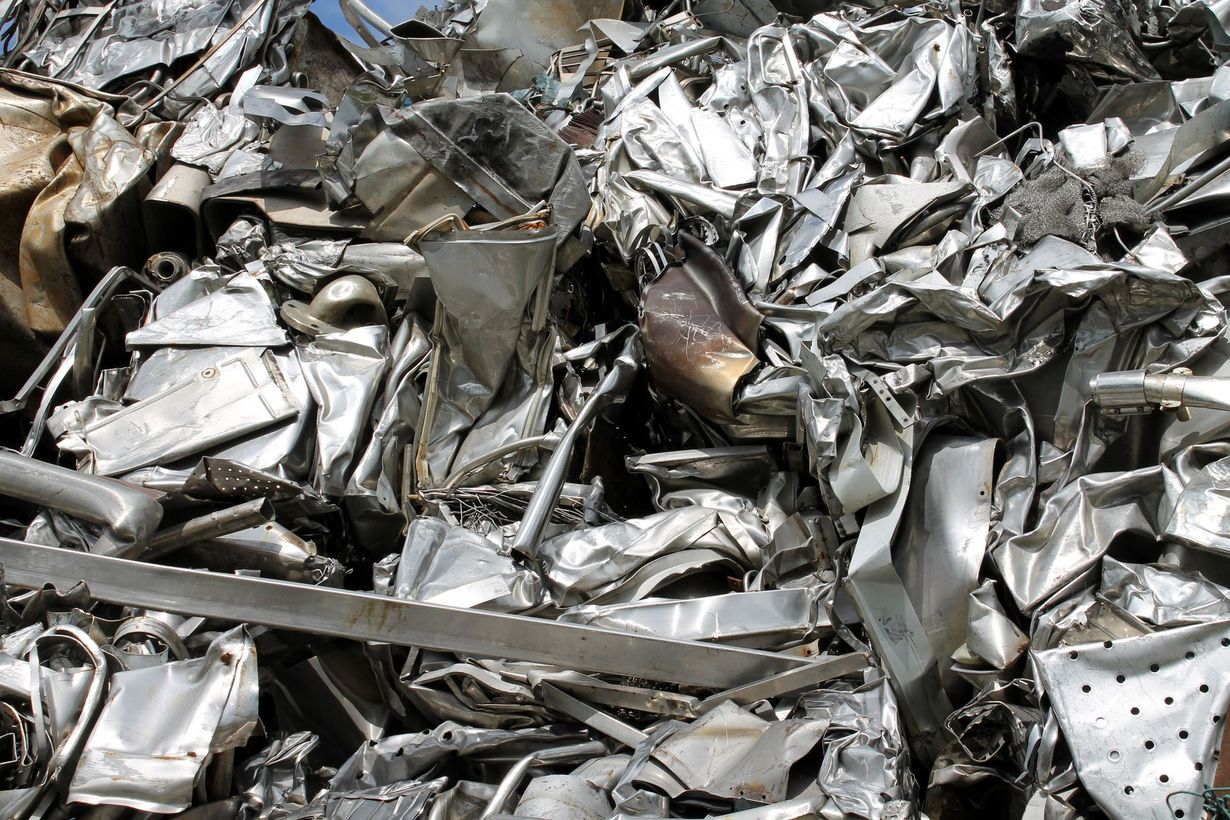 A large, chaotic pile of crumpled, shiny silver and grey scrap metal.