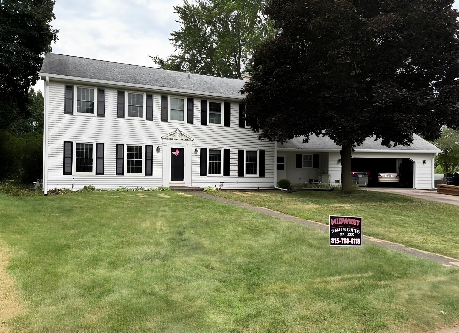 A large house with white siding - Before