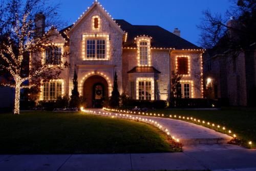 Two-story house decorated with white Christmas lights