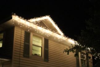 House with white Christmas lights along the roofline