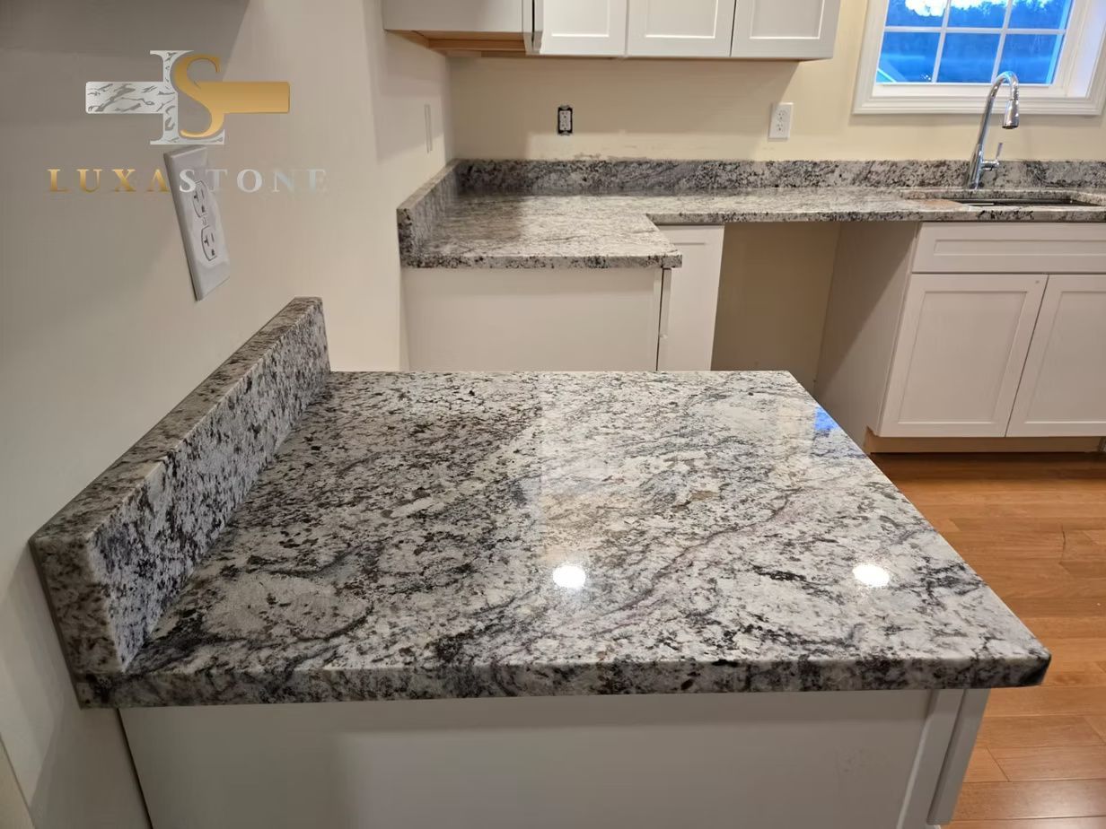 Kitchen with granite countertops and white cabinets.
