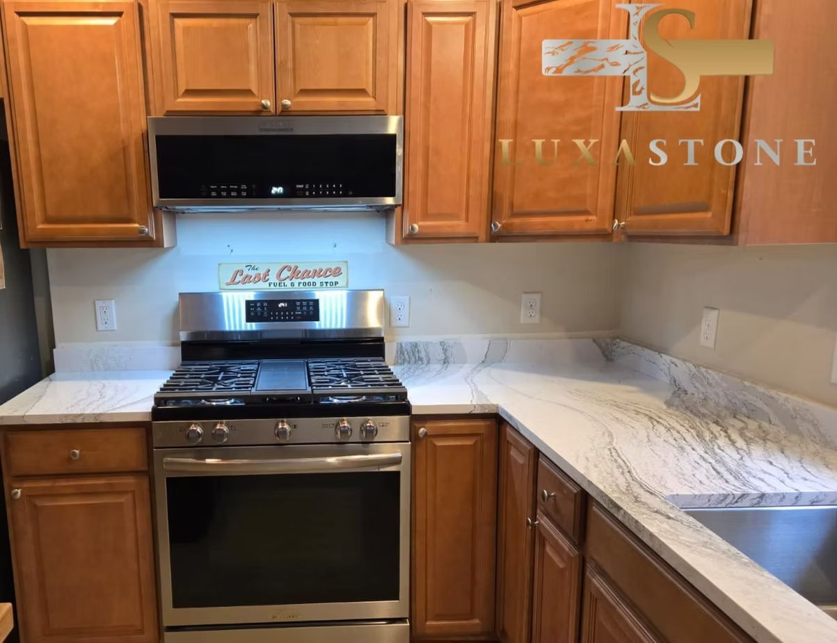 Kitchen with light countertops, wooden cabinets, and a stainless steel stove.