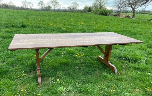 A large oak table base made from reclaimed quartersawn and truck bed white oak