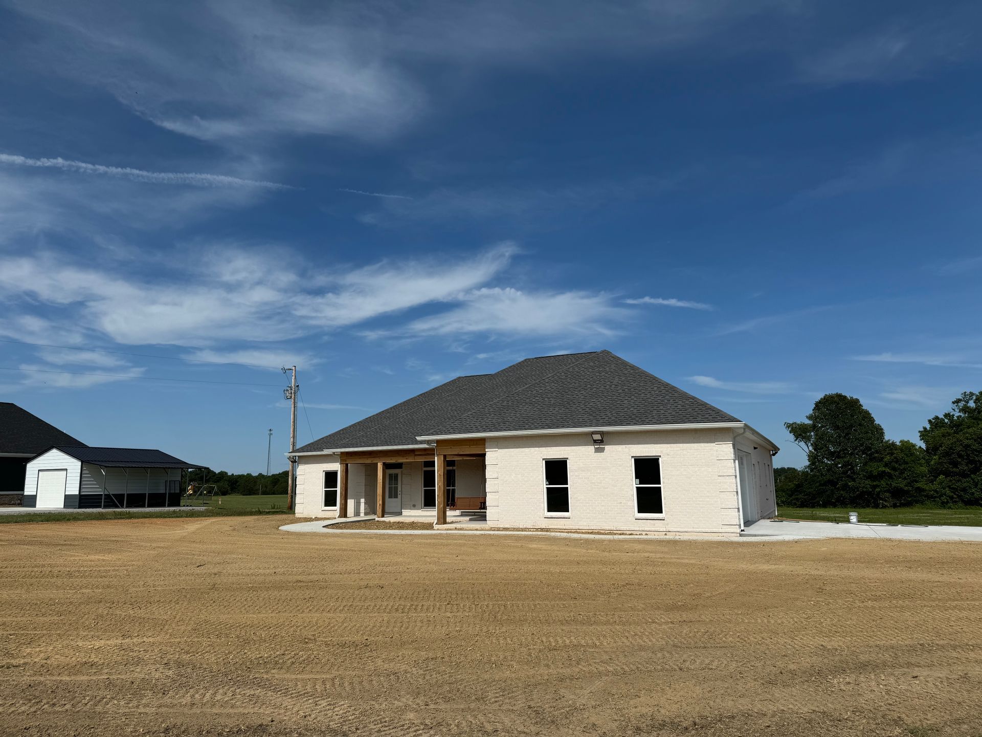 A house that is being built in a field.