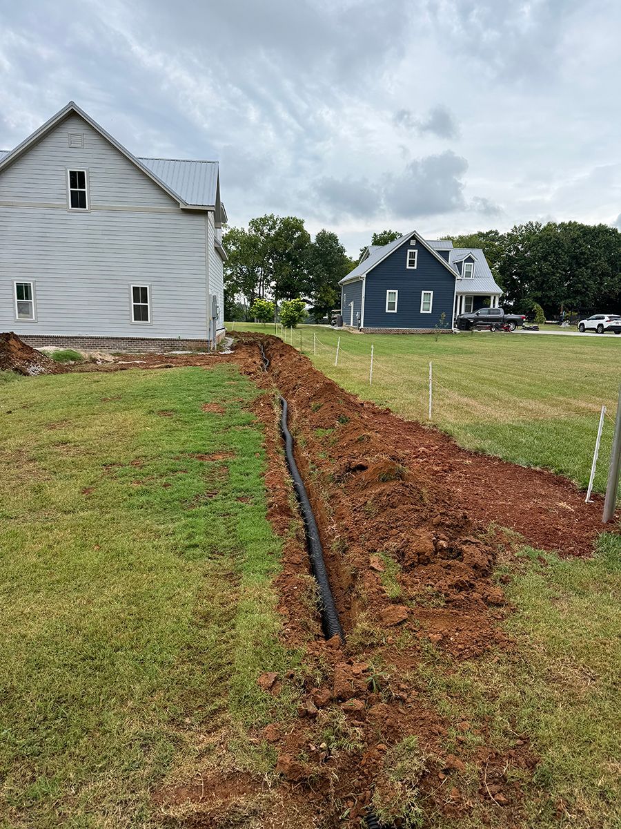 A house is being built in the middle of a grassy field.