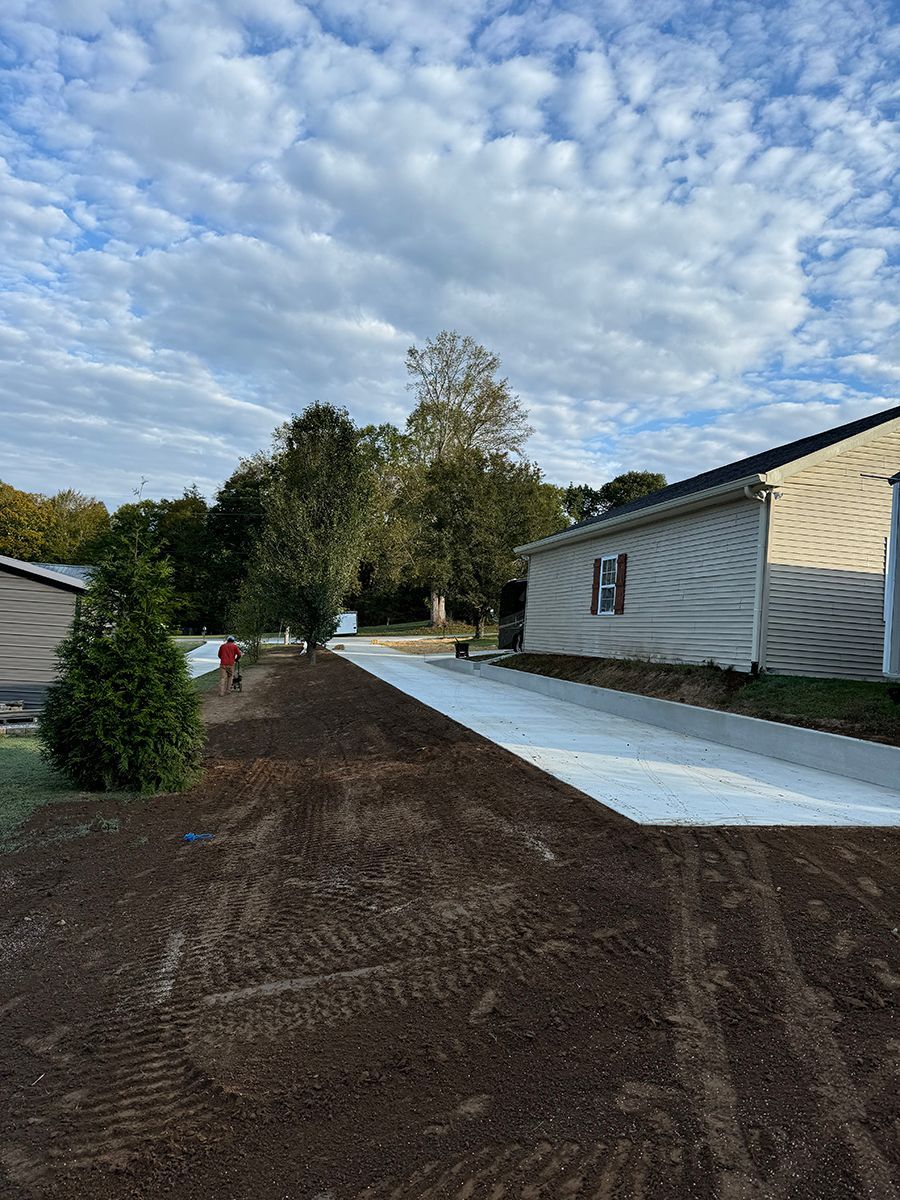 A concrete driveway is being built in front of a house.