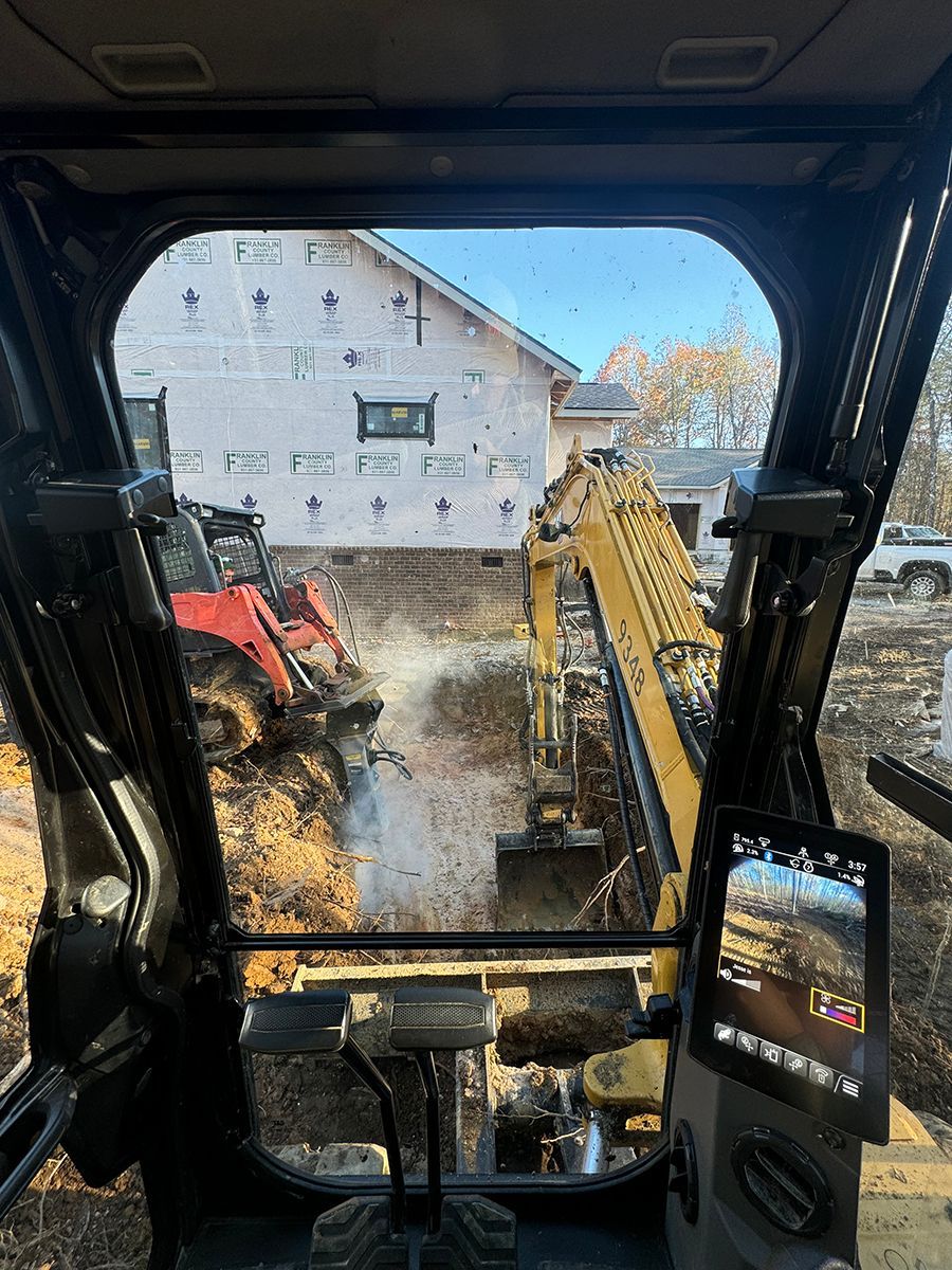 A view of a construction site from the inside of a bulldozer.