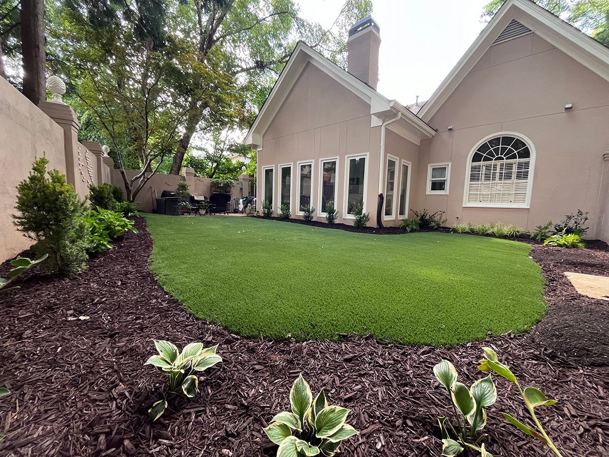 A large house with a lush green lawn in front of it.