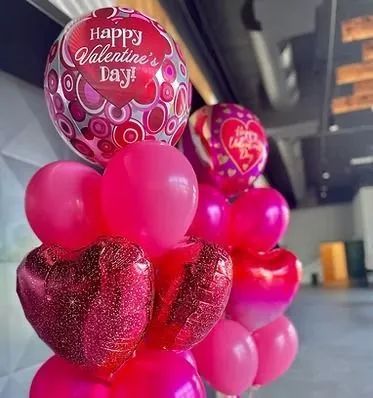 Valentine’s Day balloon bouquet with pink and red heart-shaped balloons indoors