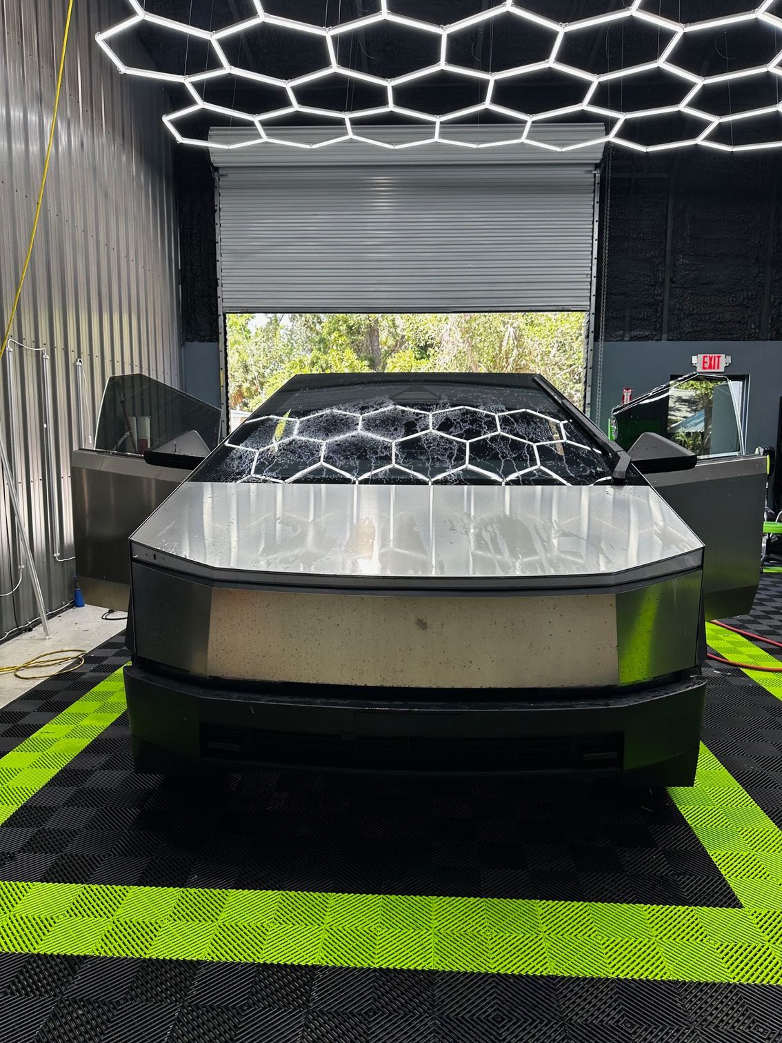 A tesla cybertruck is parked in a garage.